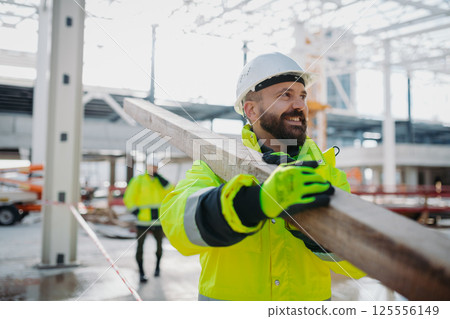 Construction workers at work on modern building site. 125556149