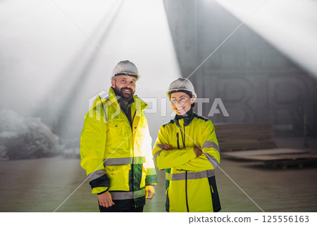 Engineers discussing construction plans using a tablet on site. Engineers discussing construction plans using a tablet on site. 125556163