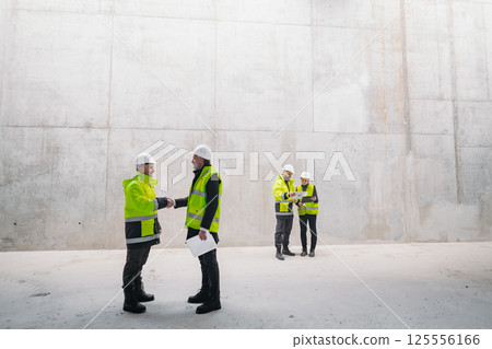 Engineer shaking hand with construction manager, building site. 125556166