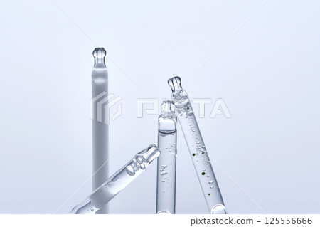 Four different droppers with facial serum in a row. 125556666