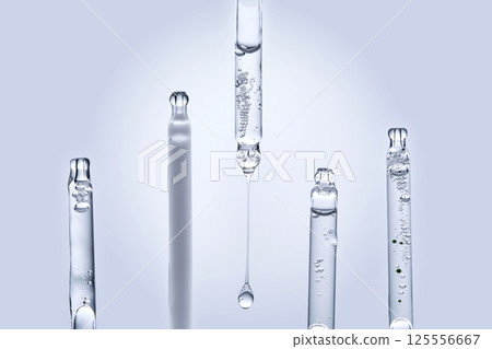 Five different droppers with facial serum in a row. Five different droppers with facial serum in a row. 125556667