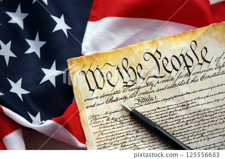 Preamble to the Constitution of the United States and American Flag close up Preamble to the Constitution of the United States and American Flag close up 125556683