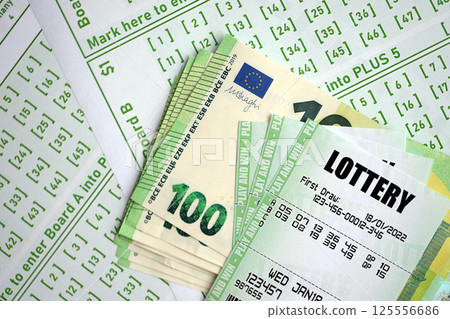 Green lottery tickets and euro money bills on blank with numbers for playing lottery Green lottery tickets and euro money bills on blank with numbers for playing lottery 125556686