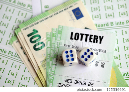 Green lottery tickets and euro money bills on blank with numbers for playing lottery Green lottery tickets and euro money bills on blank with numbers for playing lottery 125556691