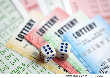 Lottery tickets of different colors and dice on blank bills with numbers for playing lottery 125556700