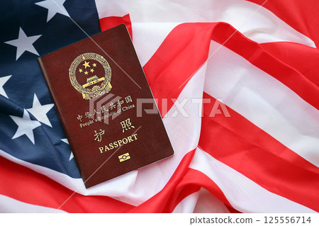 Red passport of People Republic of China on United States flag 125556714