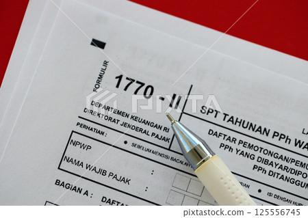 Indonesian tax form 1770-2 Individual Income Tax Return and pen on table 125556745