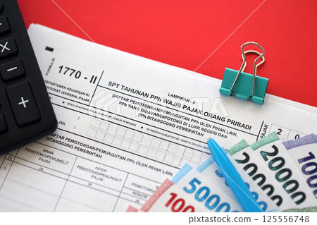 Indonesian tax form 1770-2 Individual Income Tax Return and pen on table 125556748