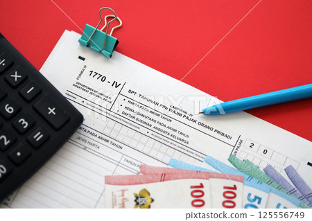 Indonesian tax form 1770-4 Individual Income Tax Return and pen on table 125556749