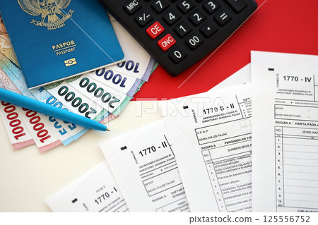 Indonesian tax forms 1770 Individual Income Tax Return and passport with pen on table 125556752