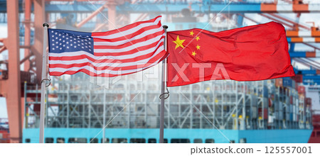 American and Chinese flags on the background of ship with containers. Symbol of trade war. 125557001
