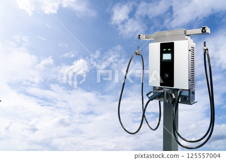 Electric vehicle charging station on the background of blue sky Electric vehicle charging station on the background of blue sky 125557004