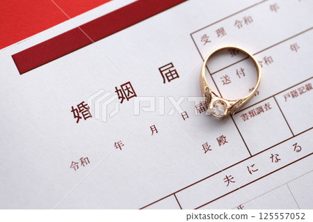 Japanese marriage registration blank document and wedding proposition ring on table 125557052