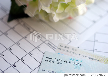 Japanese my number card specimen and notification card on calendar background Japanese my number card specimen and notification card on calendar background 125557077