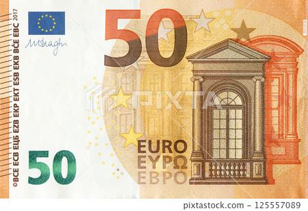Fragment of one fifty euro money bill. Details of European union currency banknote of 50 euro 125557089