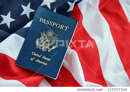 Blue United States of America passport on national flag background close up Blue United States of America passport on national flag background close up 125557104