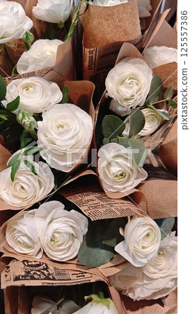 Elegant white ranunculus flowers wrapped Elegant white ranunculus flowers wrapped 125557386