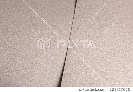 Background with paper texture. Satin pearlescent surface with glossy folded overlap, vertical layout 125557668
