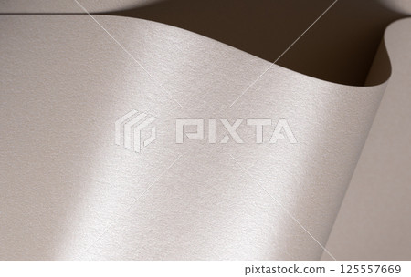 Background with satin paper texture. Curved folded surface with pearlescent shimmer in champagne, 125557669
