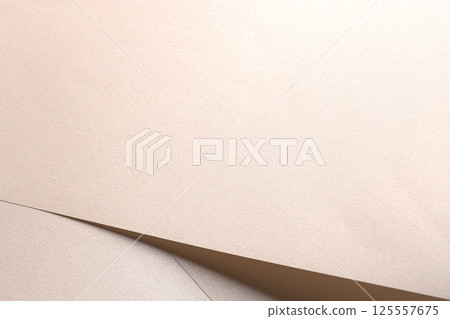 Background with satin paper texture. Glossy surface with pearlescent shimmer, folded overlap in pale 125557675