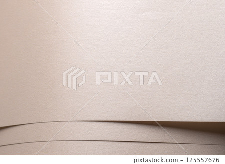Background with satin paper texture. Layered horizontal strips in champagne, beige, pale gold. 125557676