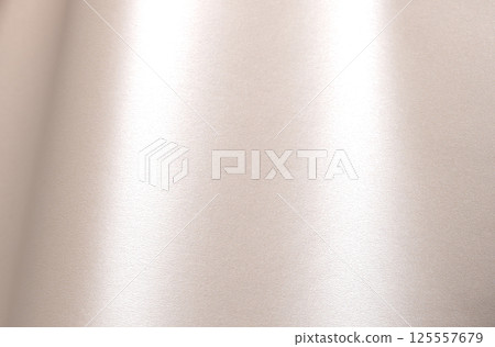 Champagne beige paper background with a pearlescent satin texture and soft, glowing sheen. Pale gold Champagne beige paper background with a pearlescent satin texture and soft, glowing sheen. Pale gold 125557679