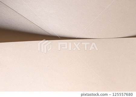 Champagne beige paper background with a pearlescent satin texture and soft, graceful folds. Pale Champagne beige paper background with a pearlescent satin texture and soft, graceful folds. Pale 125557680