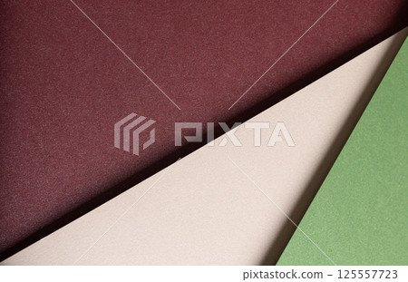 Paper background with matte texture. Layered diagonal sheets in burgundy, maroon, champagne, soft 125557723