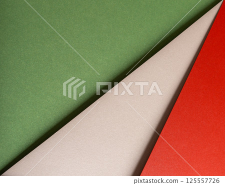Paper background with matte texture. Layered diagonal sheets in crimson red, pastel green, mint Paper background with matte texture. Layered diagonal sheets in crimson red, pastel green, mint 125557726