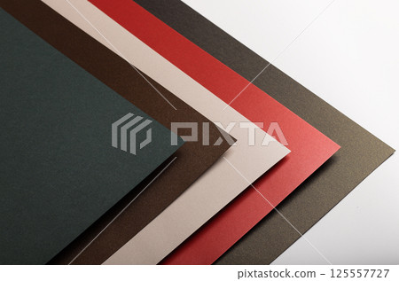 Paper background with matte texture. Layered diagonal sheets in crimson red, soft beige, champagne, Paper background with matte texture. Layered diagonal sheets in crimson red, soft beige, champagne, 125557727