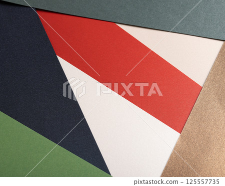 Paper background with matte texture. Layered geometric triangles in crimson red, pastel green, 125557735
