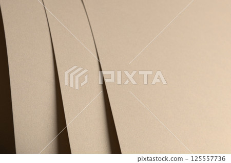 Paper background with matte texture. Layered smooth sheets in beige, light brown, and golden tones, 125557736