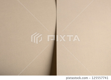 Paper background with matte texture. Smooth golden beige surface in soft pastel hue, grainy 125557741