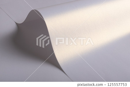 Paper background with satin pearlescent texture. Glossy folded curves, smooth surface in pale lilac 125557753