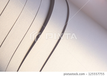 Paper background with satin pearlescent texture. Glossy folded strips, smooth layered surface in Paper background with satin pearlescent texture. Glossy folded strips, smooth layered surface in 125557755
