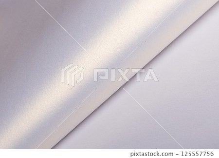 Paper background with satin pearlescent texture. Glossy folded surface with soft curve and gradient, 125557756