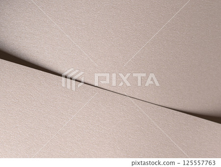 Paper background with satin pearlescent texture. Matte folded surface with diagonal overlap, pale Paper background with satin pearlescent texture. Matte folded surface with diagonal overlap, pale 125557763