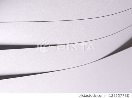 White pearl paper background with a satin, glossy texture and softly curved layered strips. Pale 125557788