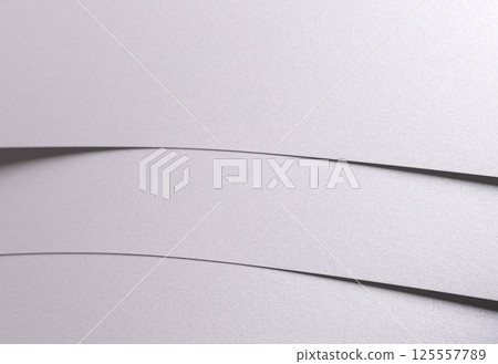 White pearl paper background with a satin, glossy texture and softly curved, layered folds. Pale 125557789