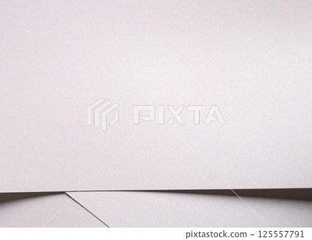 White pearl paper background with a satin, glossy texture and softly folded, layered waves. Pale 125557791