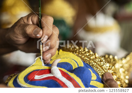 close up of artist painting lakhon khol traditional mask in cambodia 125558927