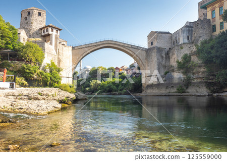 The Stari Most bridge, old bridge on Neretva river in Mostar town, Bosnia and Herzegovina, Europe. Iconic stone bridge arching over a river, blending history and architecture with natural beauty. 125559000