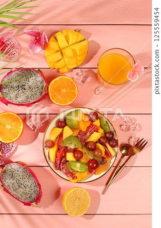 Fruit kitchen background with ingredients for making salad. Dragon fruit, mango, kiwi, orange, nuts and dried apricots, exotic fruits for a healthy lifestyle, advertising banner for a cafe, Fruit kitchen background with ingredients for making salad. Dragon fruit, mango, kiwi, orange, nuts and dried apricots, exotic fruits for a healthy lifestyle, advertising banner for a cafe, 125559454