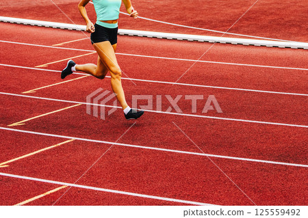 Run, track and fied banner with copy space. Running womans legs Run, track and fied banner with copy space. Running womans legs 125559492