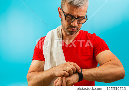 Man checking smartwatch during workout in gym Man checking smartwatch during workout in gym 125559713