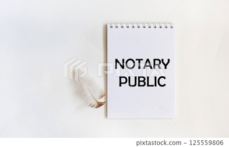A notebook with the text NOTARY PUBLIC on a white background 125559806