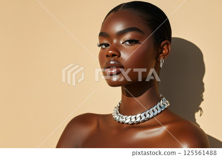 Model showcasing elegant silver necklace against minimalist backdrop with natural lighting 125561488