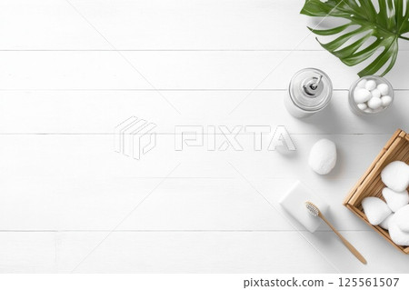 Bright minimalist bathroom countertop with bamboo toothbrush holder and simple decor elements 125561507