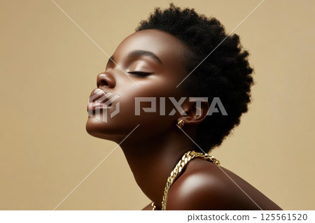 Model with chunky gold chain poses in minimalist studio with soft lighting Model with chunky gold chain poses in minimalist studio with soft lighting 125561520