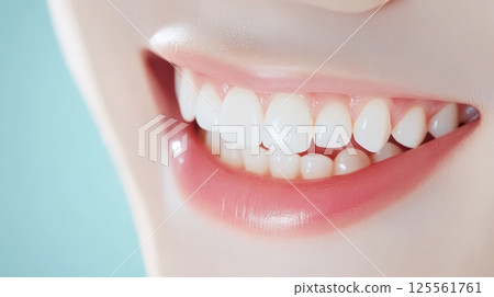 Capturing a close up of a perfect smile featuring bright white teeth and soft pink lips, embodying ideals of oral hygiene, dental care, and cosmetology while radiating beauty and confidence 125561761